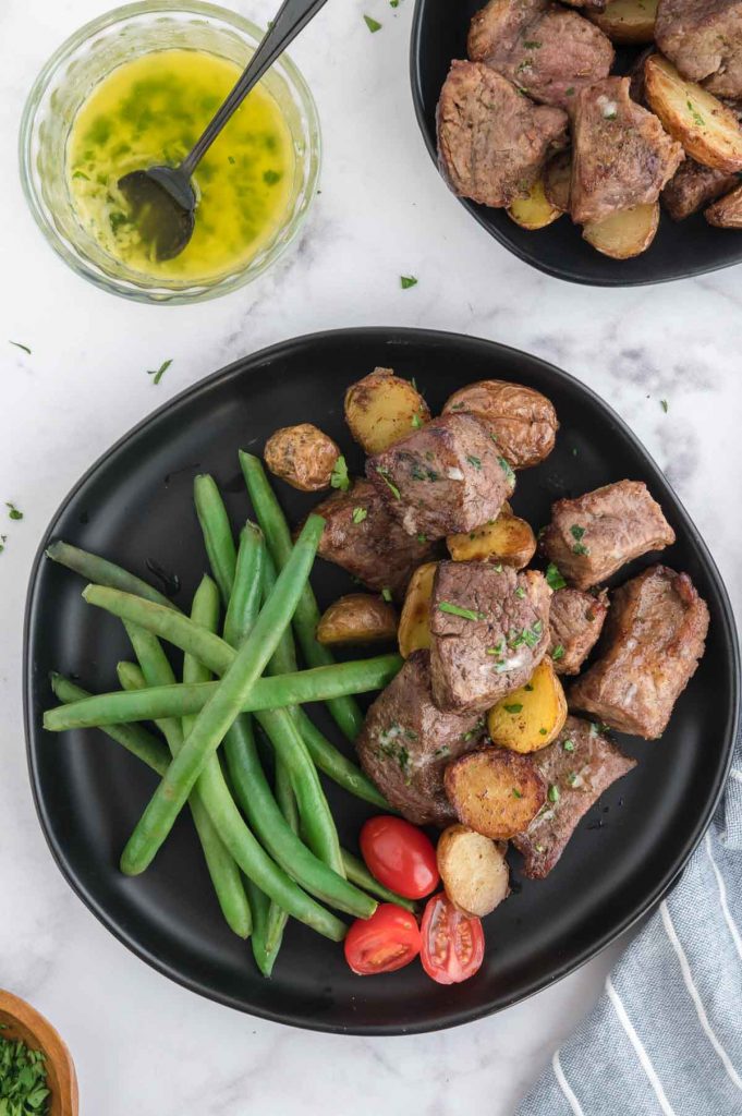 dinner plate with steak bites and green beans on it