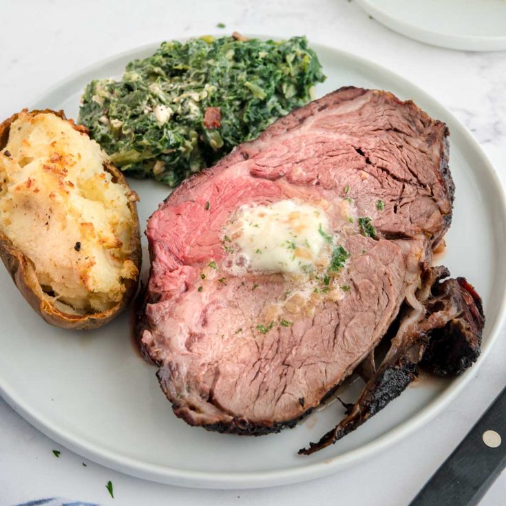 plate with prime rib dinner made on the grill