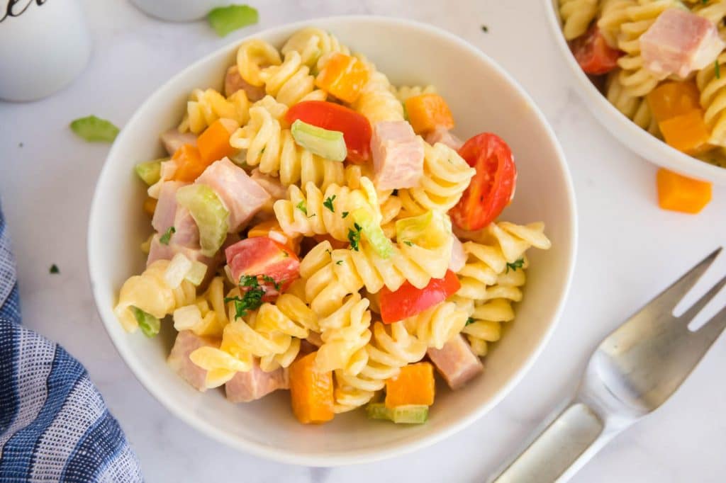 Serving bowl of pasta salad on a table