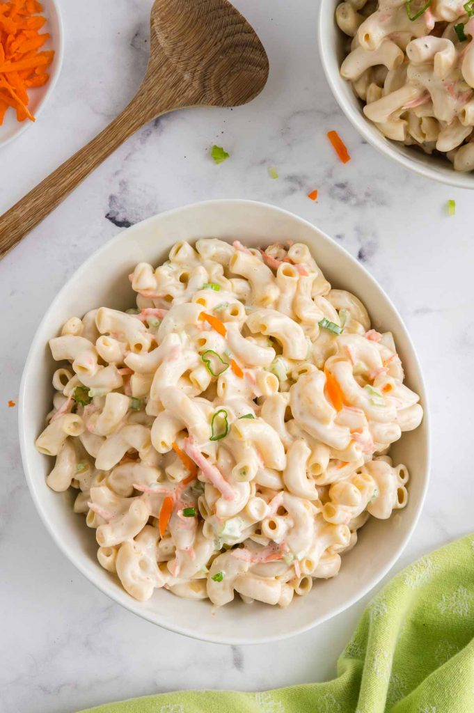bowl of Hawaiian style macaroni salad with a wooden spoon next to it