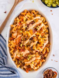 Serving dish full of cheeseburger pasta with added bacon