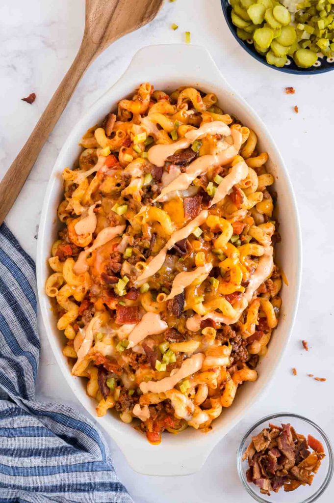 Serving dish full of cheeseburger pasta with added bacon